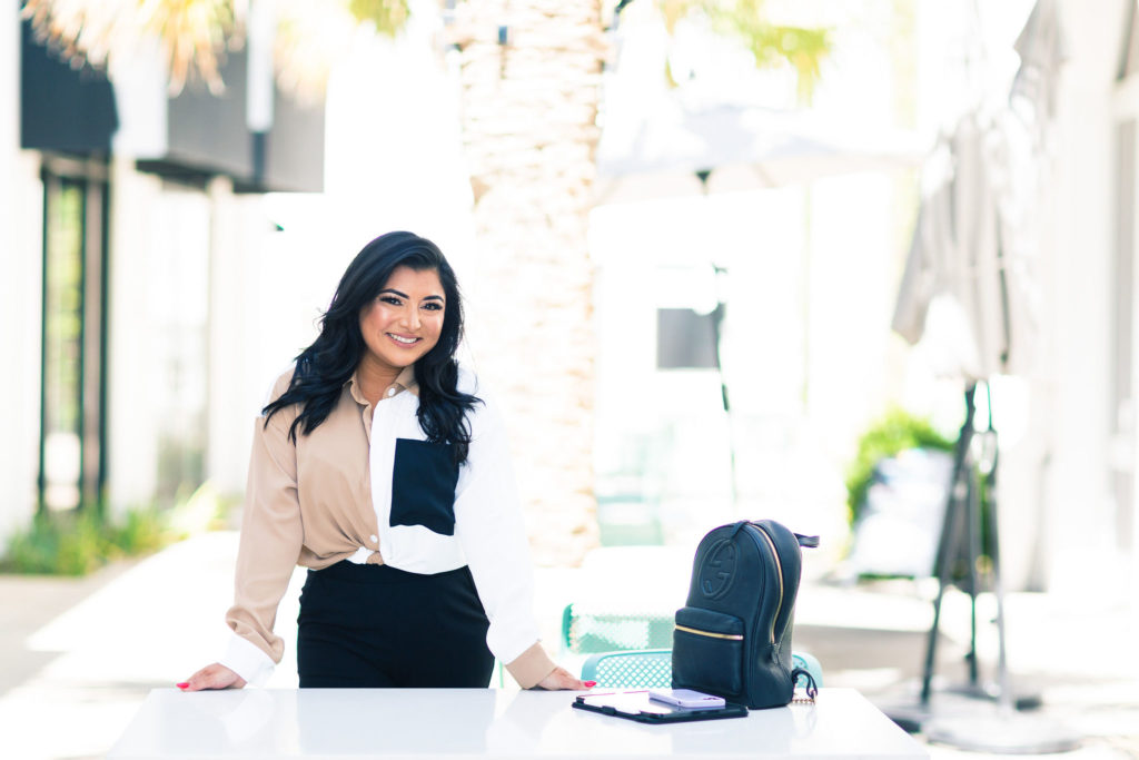 Female CEO standing outside with hands on a table